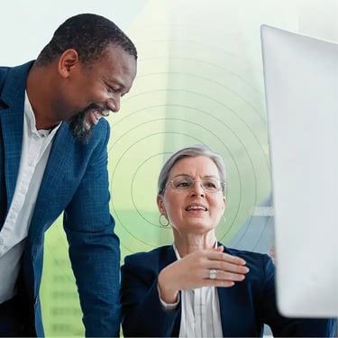 Coworkers looking at desktop together